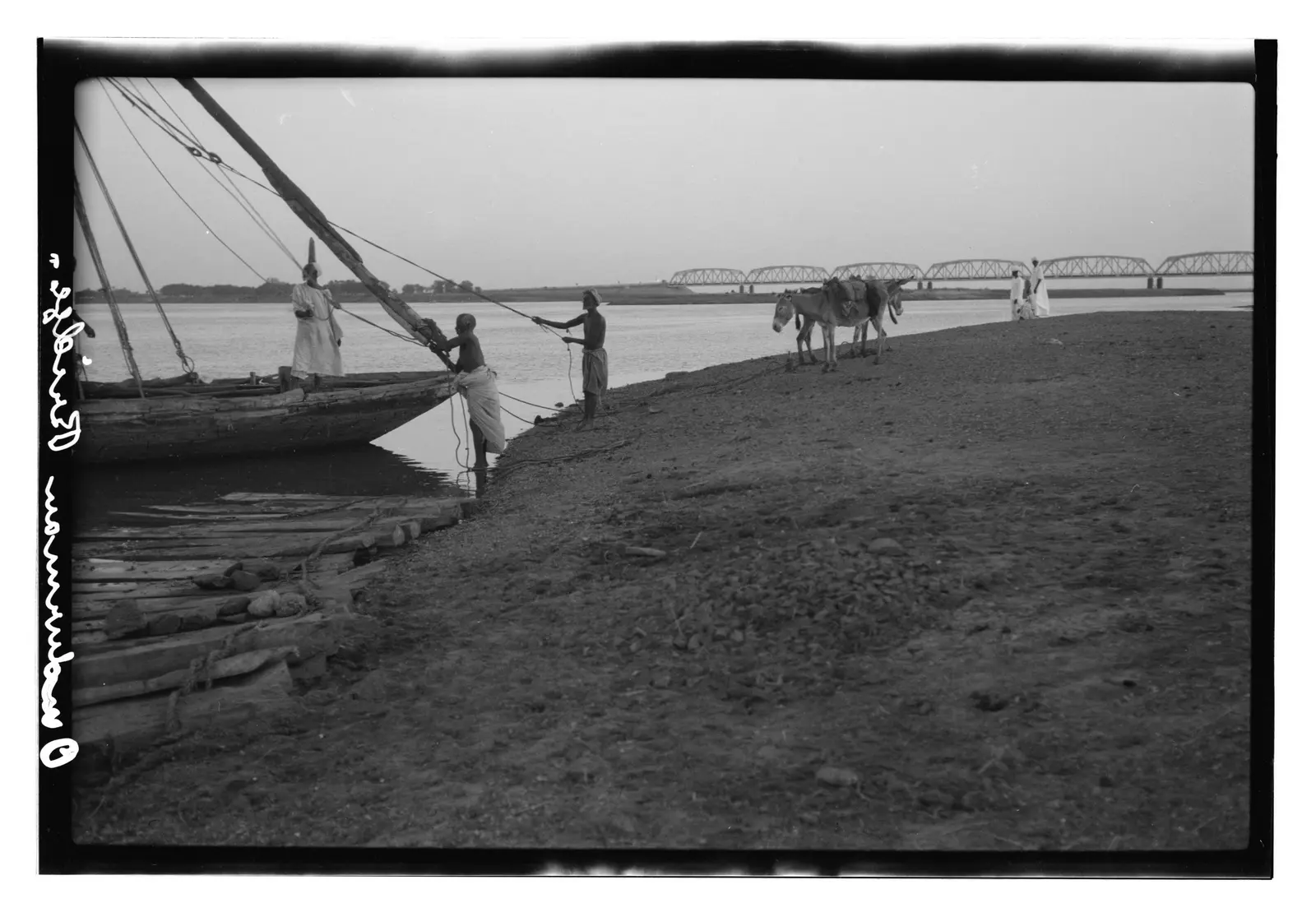 Men with boat, Omdurman Bridge behind (1936)